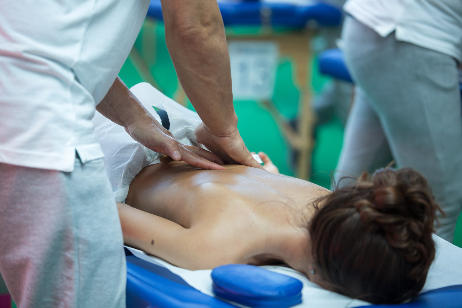 athlete receiving professional back massage - Pan Thai Massage