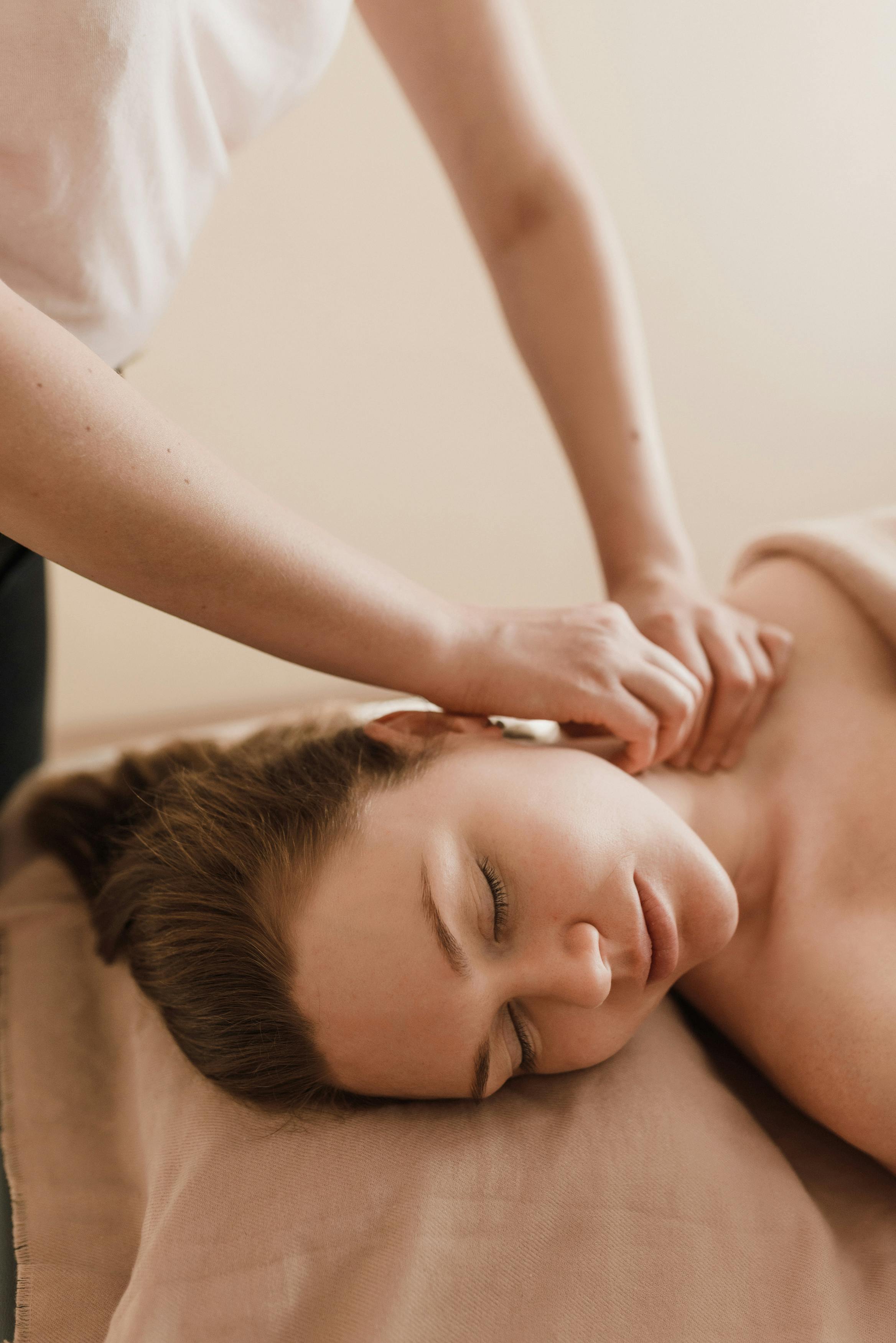 Massage therapist massaging customer's neck for pain relief - Pan Thai Massage - Sugar Land, TX