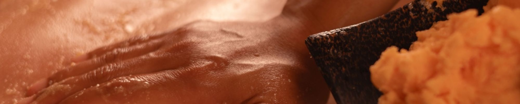A massage therapist performing Houston body scrub massage